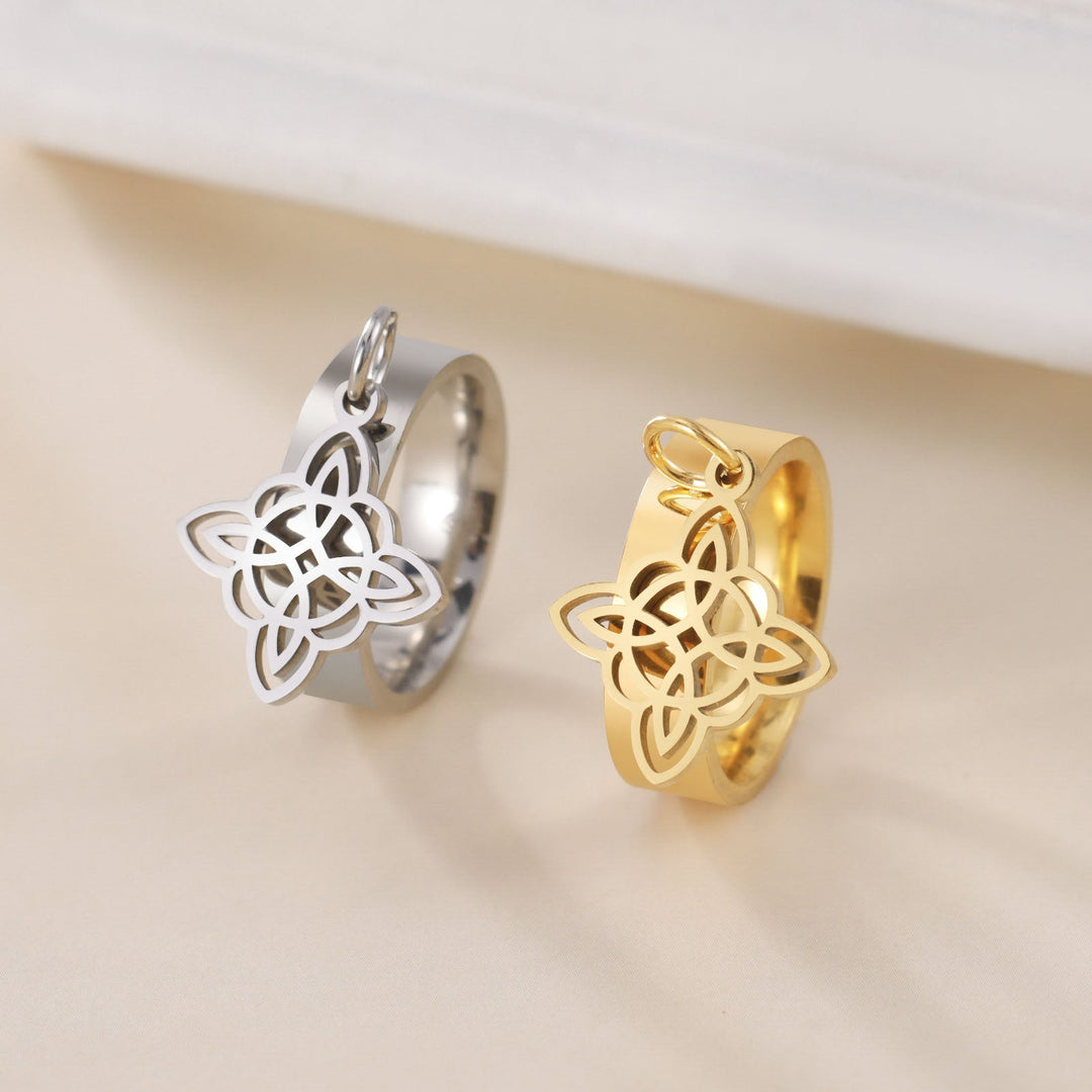 Pictured here are two of THE GUARDIAN'S WITCHES KNOT DANGLE rings, one in silver color and the other in gold color, made of stainless steel with a Witch Knot element