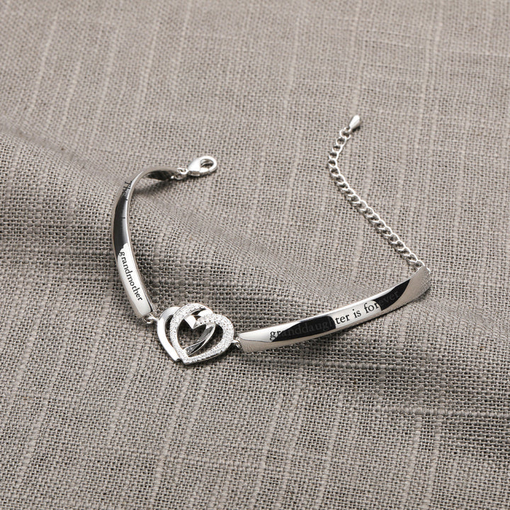 Design Interpretation: 'Forever Linked Together' Double Heart Bracelet - A meaningful copper bracelet featuring engraved words 'The love between grandmother granddaughter is forever' and two intertwined hearts, symbolizing an inseparable bond. Perfect for gifting to your granddaughter to remind her of your eternal connection.