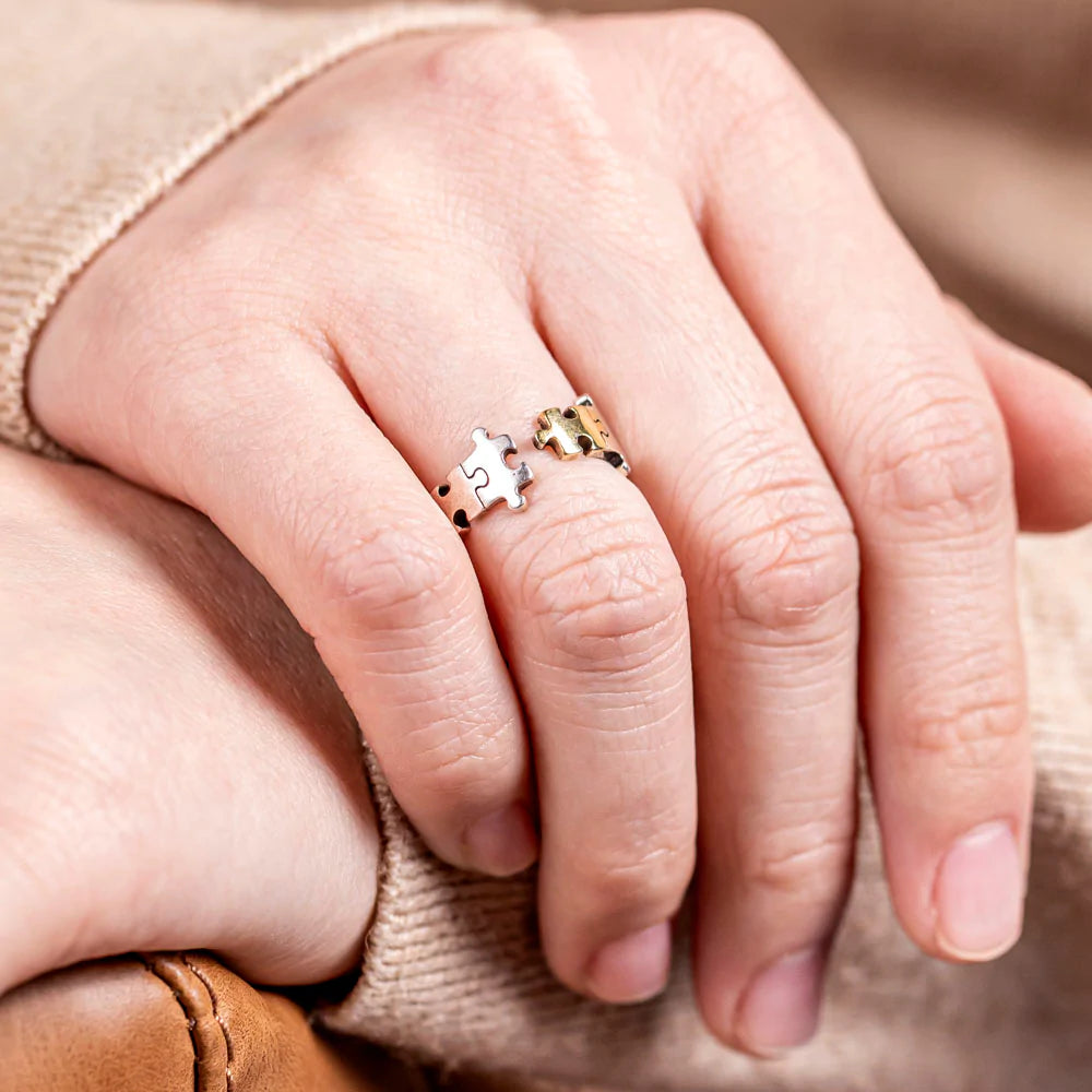 To My Daughter 'You Shine and Sparkle Differently' Puzzle Ring - A unique copper ring with a special gold-colored piece in the middle, symbolizing the distinctive and special nature of your daughter. This thoughtful gift comes with an inspiring greeting card, a gift box, and a gift bag, reminding her of her unique sparkle and individuality. Suitable for all ages