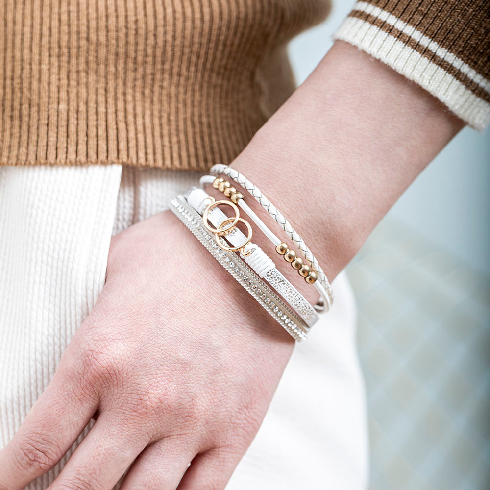 A close-up view of a leather bracelet with two interlocking rings at its center, representing the eternal bond between a granddaughter and a grandmother. The bracelet is accompanied by a greeting card and packaged in a gift box and bag. Material: Leather. Processing Techniques: Plating. Suitable for all ages."