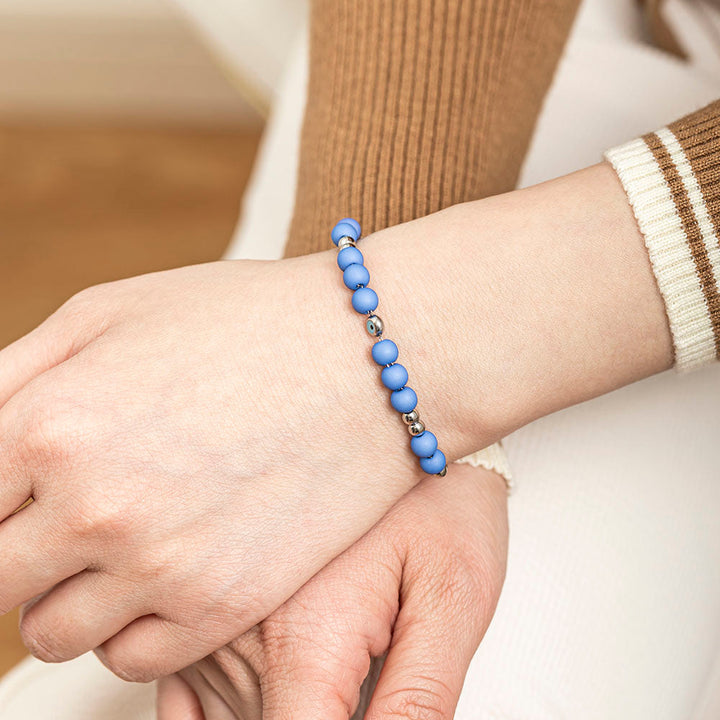 A titanium steel bracelet featuring an evil eye design, symbolizing protection from negativity and harm. Accompanied by a greeting card, gift box, and bag. Material: Titanium steel. Processing Techniques: Plating. Suitable for all ages.