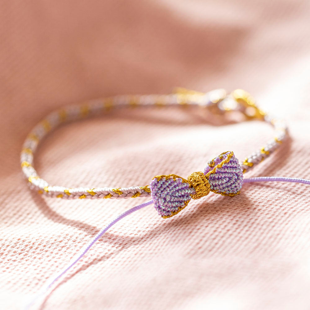 Knitted bowknot bracelet with an inspirational message. Perfect for wishing luck and support. The image depicts a stylish bracelet adorned with a bowknot, symbolizing encouragement and well-wishes for the wearer's journey