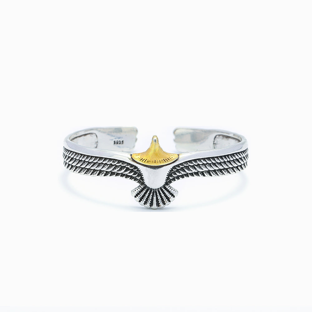 Stylish cuff bracelet with wing design, presented with a greeting card, gift box, and bag.