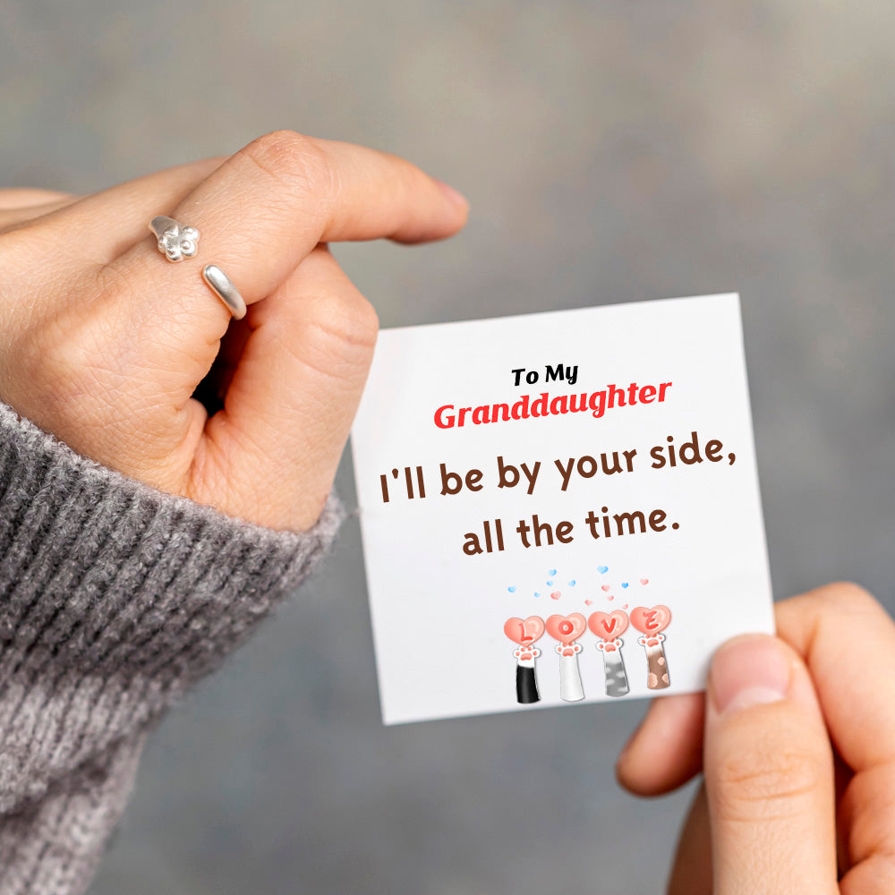 Sterling silver ring with cat paw design, accompanied by a greeting card in a gift box.