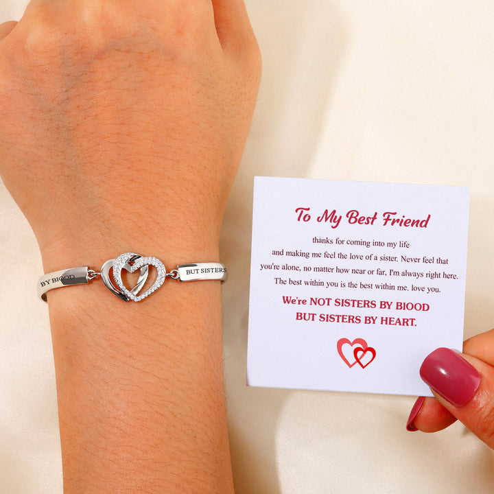 Double Heart Bracelet with intertwined rings, engraved with "Not sisters by blood but sisters by heart", symbolizing strong friendship bonds, made of copper with plating finish