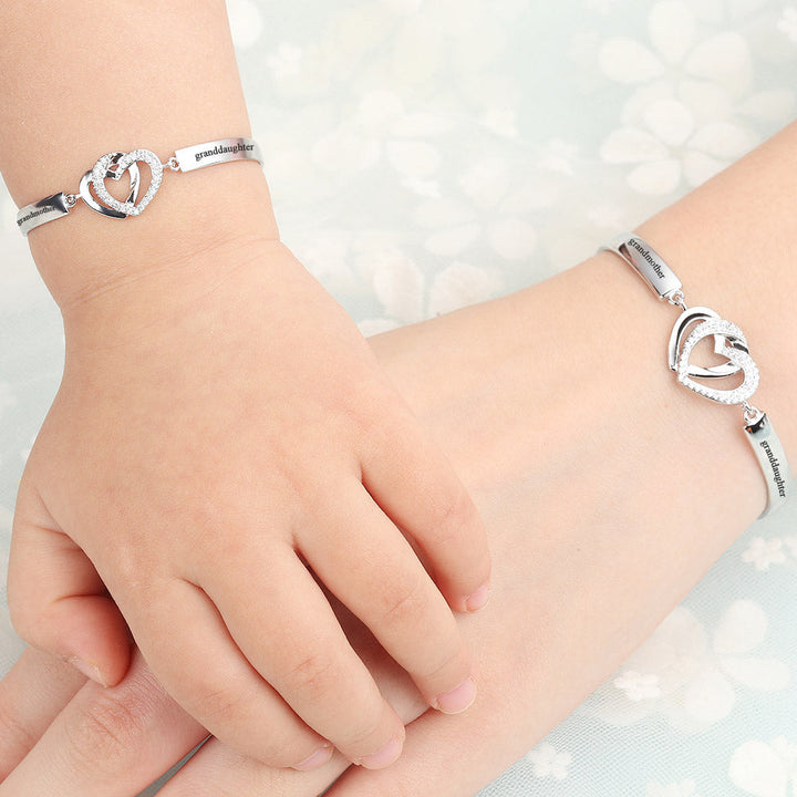 Design Interpretation: 'Forever Linked Together' Double Heart Bracelet - A meaningful copper bracelet featuring engraved words 'The love between grandmother granddaughter is forever' and two intertwined hearts, symbolizing an inseparable bond. Perfect for gifting to your granddaughter to remind her of your eternal connection.