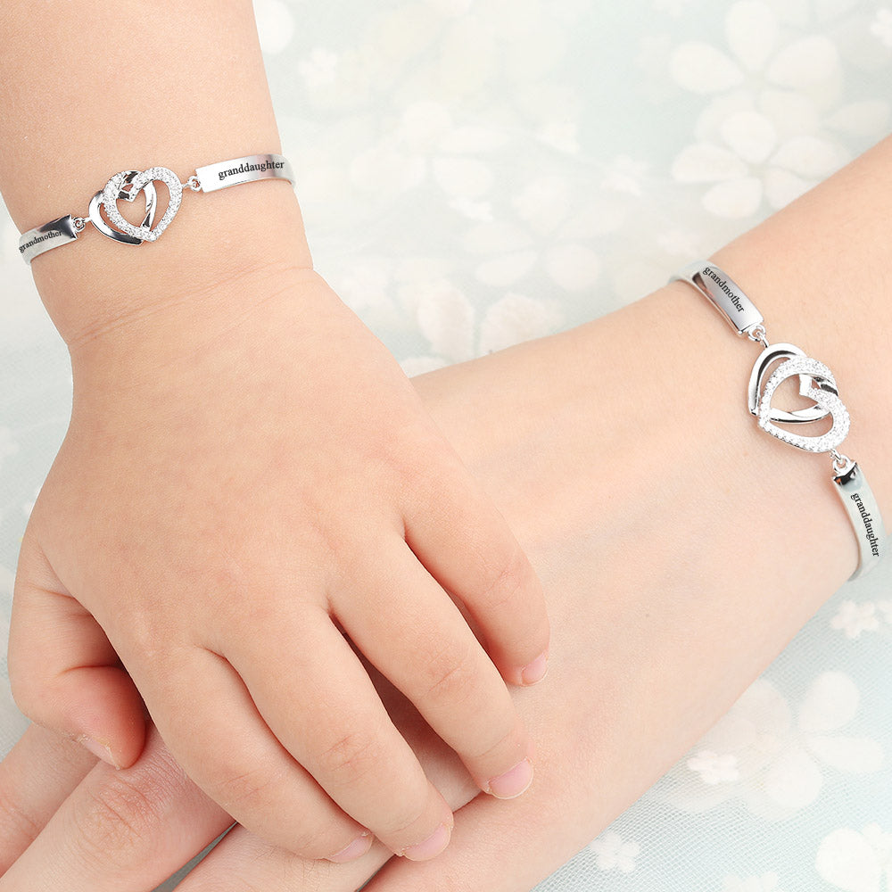 Design Interpretation: 'Forever Linked Together' Double Heart Bracelet - A meaningful copper bracelet featuring engraved words 'The love between grandmother granddaughter is forever' and two intertwined hearts, symbolizing an inseparable bond. Perfect for gifting to your granddaughter to remind her of your eternal connection.