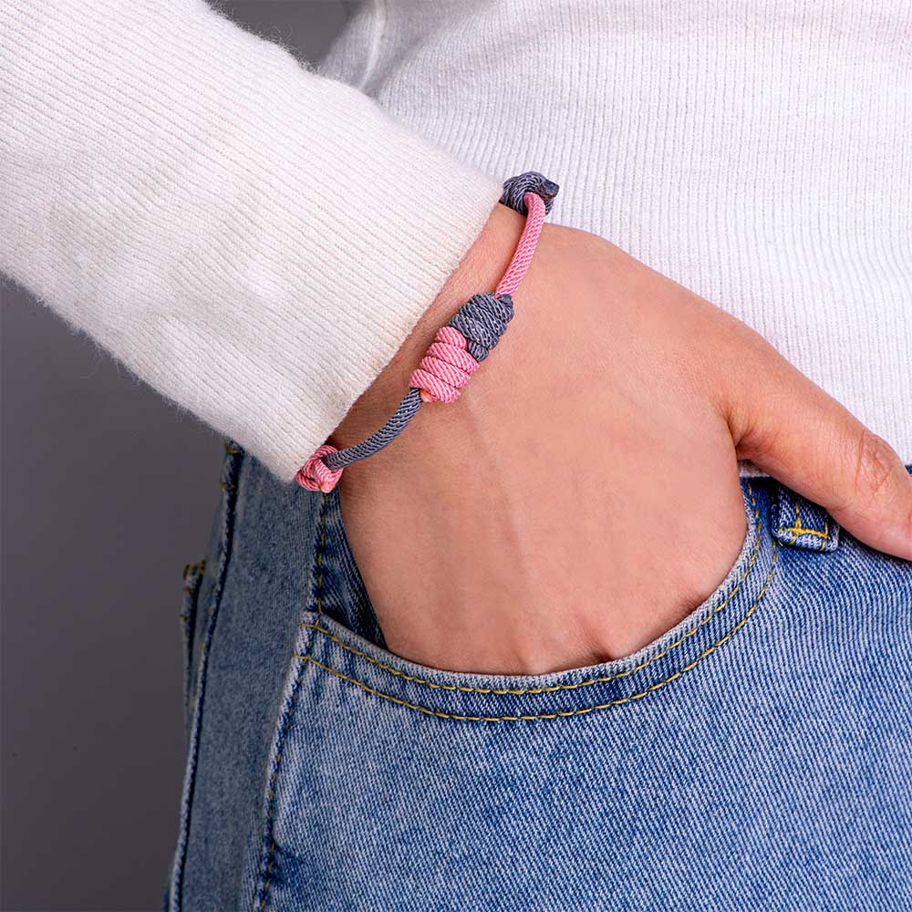 Purple and pink braided bracelet with a heartfelt message card in a gift box.