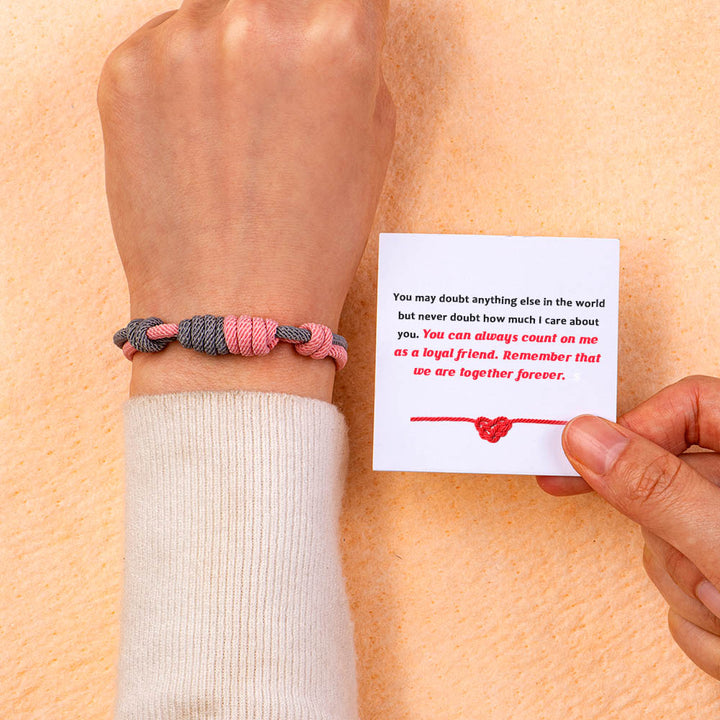 Purple and pink braided bracelet with a heartfelt message card in a gift box.