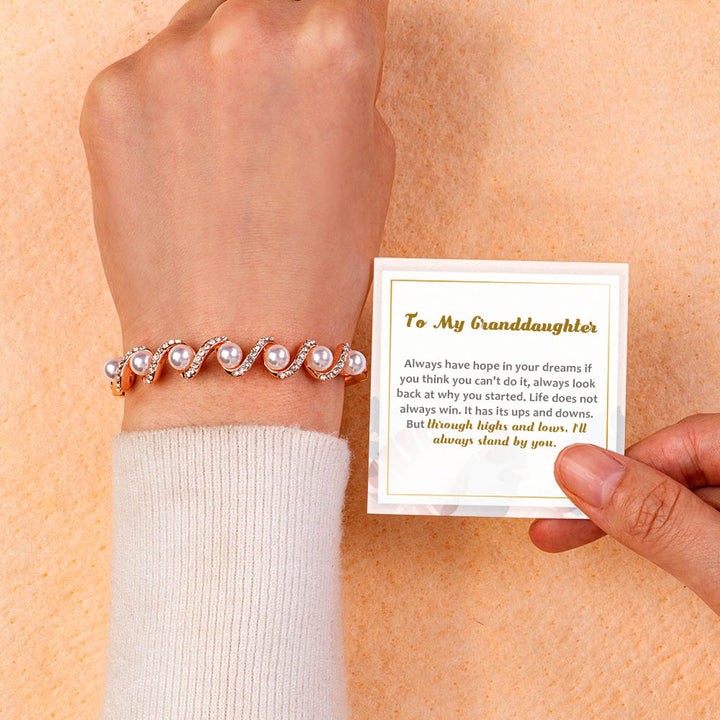 Elegant wavy pearl bracelet with an inspirational message card in a gift box.