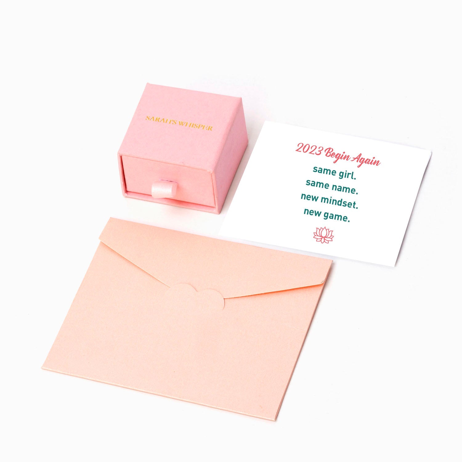 The image shows a greeting card, a gift box, and an envelope. The greeting card reads 